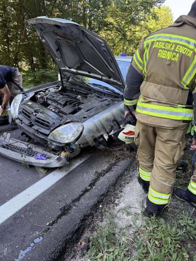 (FOTO) V vozilu ostala poškodovana oseba, prvo pomoč so ji nudili mimoidoči